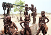 Namibia. Himba children pumping water for cattle.